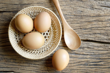 egg in wicker basket on wood table