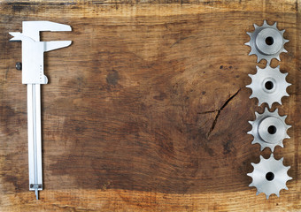 Engineering tools gears and caliper on wooden table. Success concept.