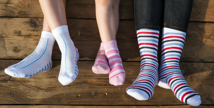 Closeup Photo Of Family Feet In Colorful Socks