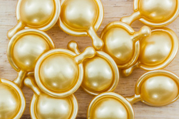 Hair vitamin serum capsule gold color.
