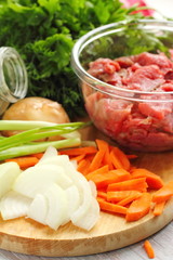Sliced onion and carrot on chopping board