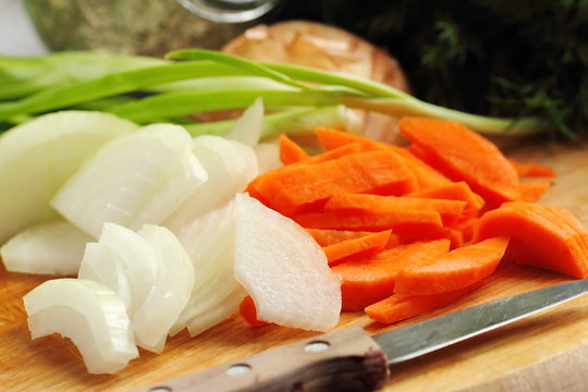 Sliced onion and carrot on chopping board