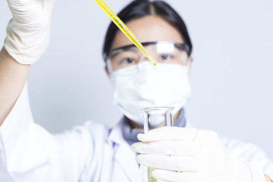 Woman Sciencetist: Researcher Holding at a Liquid Solution on Is