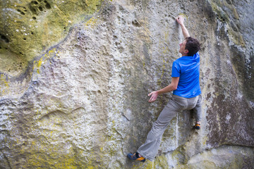Climber is bouldering on the rocks.