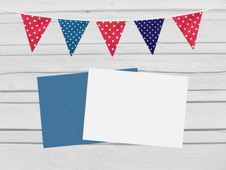 Birthday, baby shower mockup scene with envelope, blank card, party flags. Wooden background. Empty space, top vie