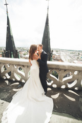 Obraz premium Gorgeous wedding couple walking in the old city of Lviv