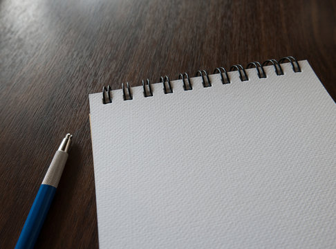 Close-up Open blank notebook with pencil
