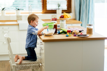 Cute child learning to become a chef