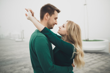 Fototapeta premium Lovely couple kissing and hugging on a sea dock
