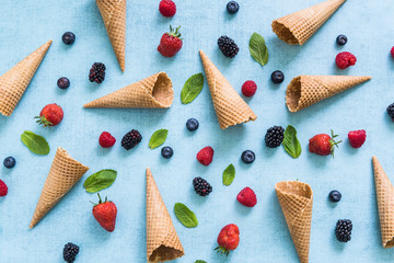 Fototapeta na wymiar ice cream cones and fresh berries, summer background