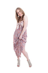 Cheerful young model wearing heels and fashionable silk dress