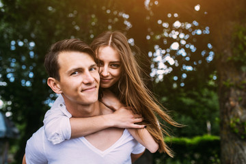 Fototapeta premium Young adult brunette man and woman in the park