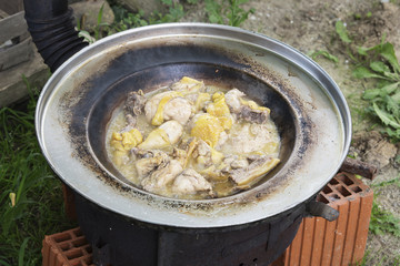 meat cooking outside on improvised grill made out of bricks