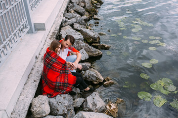 Young beautiful couple sitting on the beach