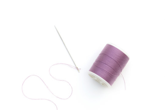 isolated purple color threads and needle