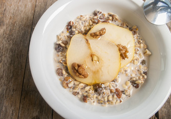 Oatmeal with pear and walnuts in the bowl