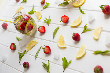 cooking strawberry lemonade on a white wooden table