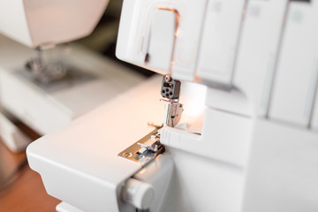 Overlock sewing machine on the workplace