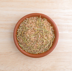 Simple blend of Tuscan seasoning in a small bowl atop a wood table.