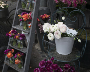 Spring bouquet with purple  ranunculus, orange tulips and anemon