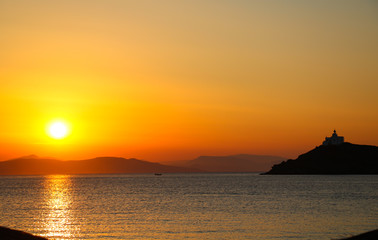 Greece - Yellow sunset over mountains at sea