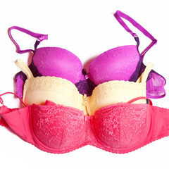 Beige bra with blue embroidery on white background