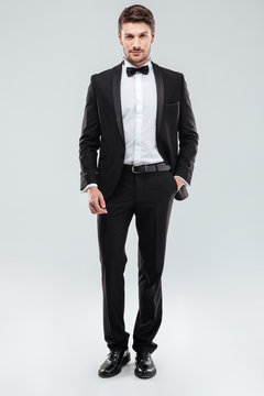 Confident attractive young man in tuxedo