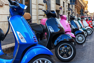 Multi-colored scooters vespa. Rental scooter in the city - obrazy, fototapety, plakaty