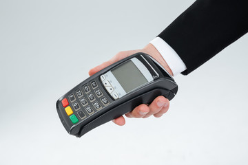 Hand of businessman holding payment terminal