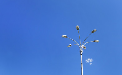 Modern streetlamp with six branches against blue skies background