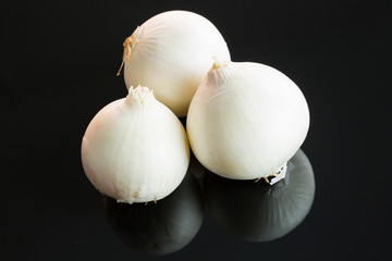 Three whole fresh raw white onions