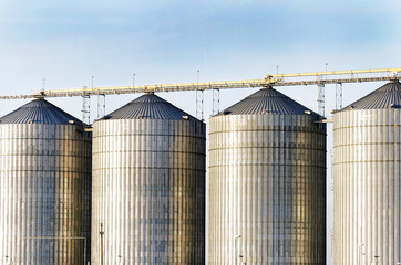 Exterior structure of new agriculture silo building. Steel grain silo towers.