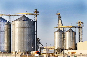 Exterior structure of new agriculture silo building. Steel grain silo towers.