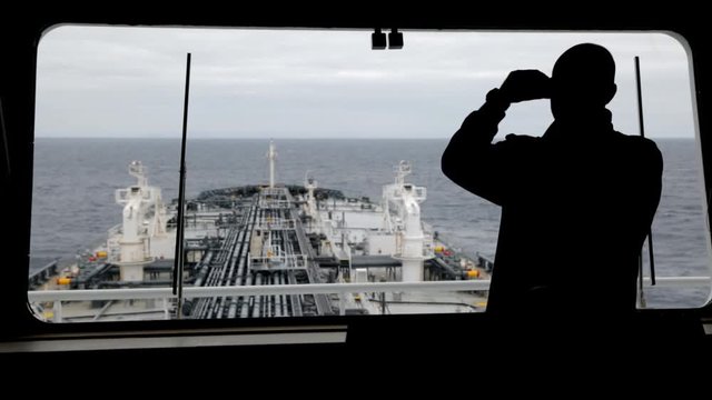 Watchman on the ship is looking forward.
