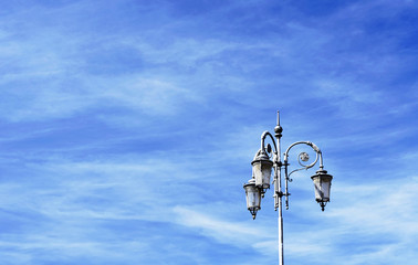 Vintage street lamp against blue sky