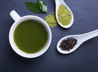 Green tea in a cup on the black background
