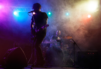 Fototapeta na wymiar Silhouette of guitar player on stage.