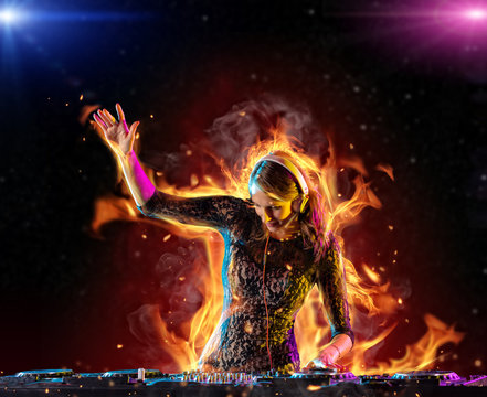 Dj girl mixing electronic music in fire