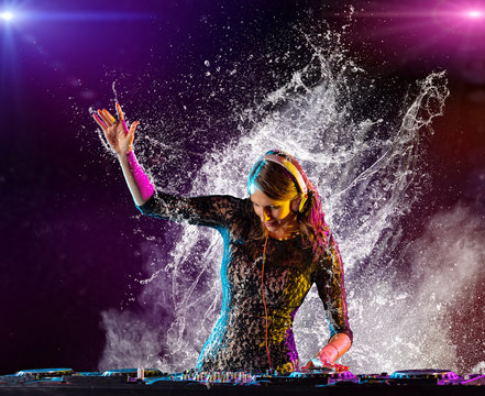 Dj girl mixing electronic music with splashes