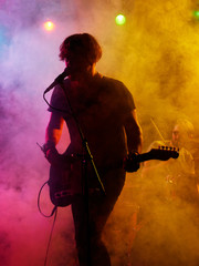 Naklejka premium Silhouette of guitar player on stage.