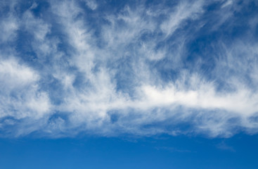 Blue sky and white clouds over horizon. Cloudy sky background.