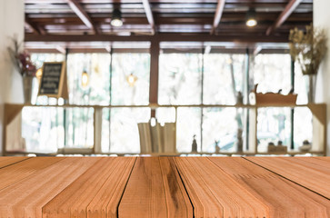 Selected focus empty brown wooden table and Coffee shop blur bac