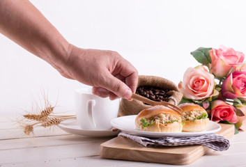 human hand prepare breakfast tuna sandwich