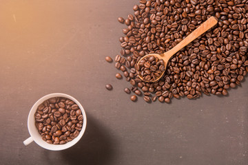 Coffee cup and coffee beans on wooden background. Top view
