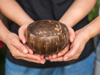Coconut bowl on hands
