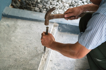 A closeup of a worker with a hammer 
