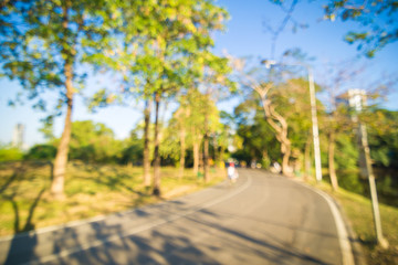 Defocused beautiful sun light at park with people exercise
