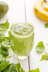 Absolutely Amazing Tasty Green Avocado Shake, Made with Fresh Avocados, Banana, Lemon Juice and Non Dairy Milk (Almond, Coconut) on Light White Wooden Background, Raw, Vegan Drink Conception, Close-up