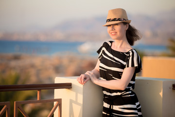 Young woman on the terrace in sunlight