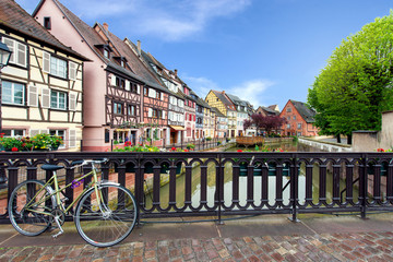 Colmar colorful traditional french houses with bicycle on the si - obrazy, fototapety, plakaty